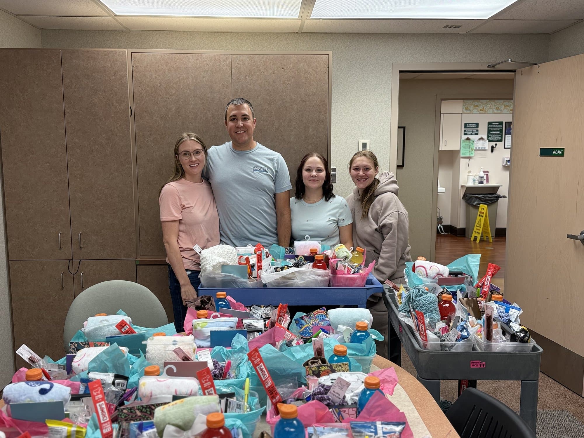 Volunteers with tables and carts full of finished care baskets ready for delivery